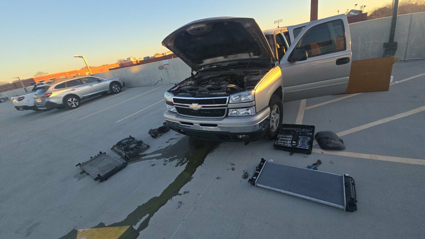 Radiator and cooling fan assembly replaced on a Chevrolet Silverado in a parking deck